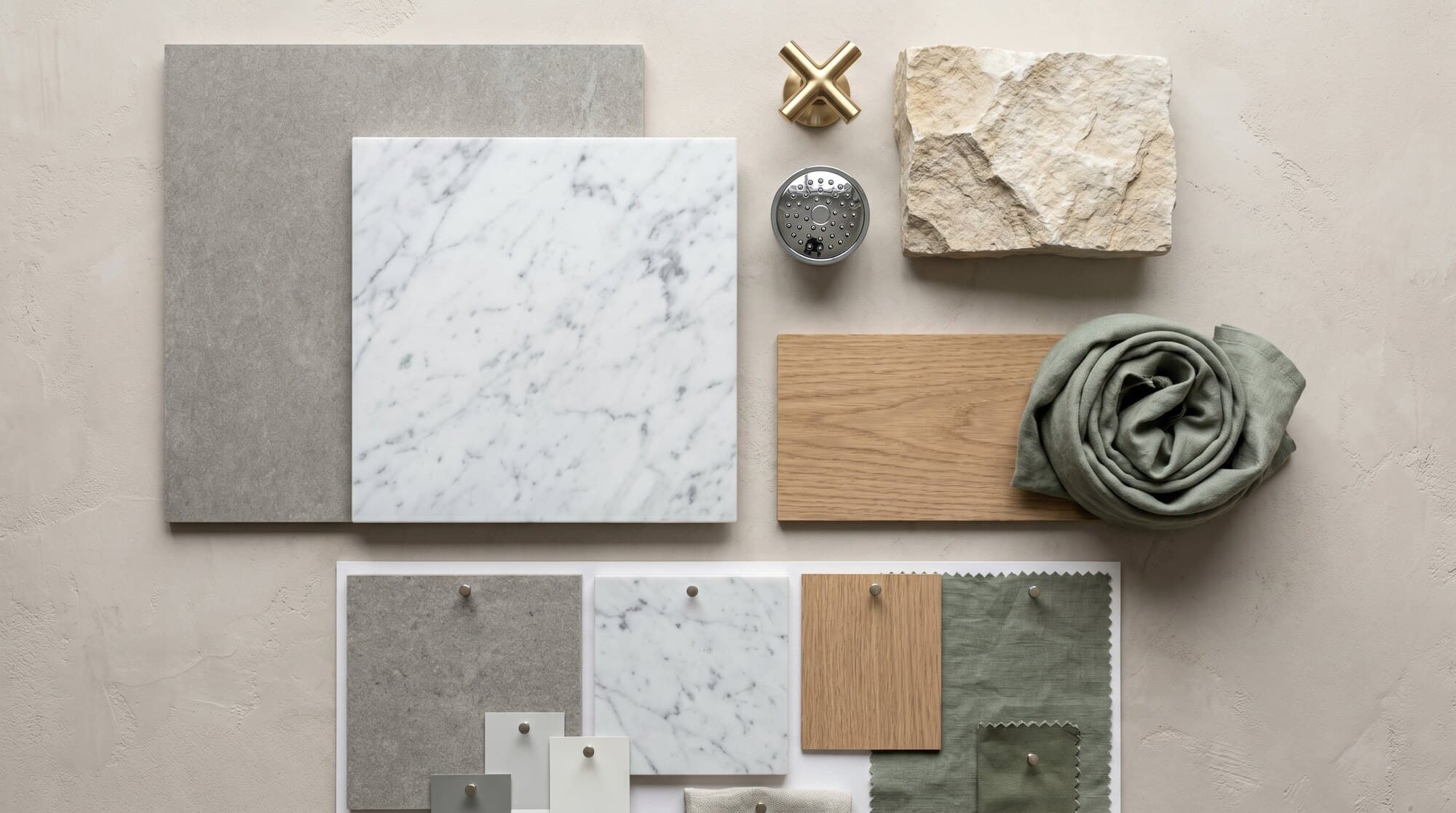 A flat-lay of bathroom materials — tile, stone and timber samples.