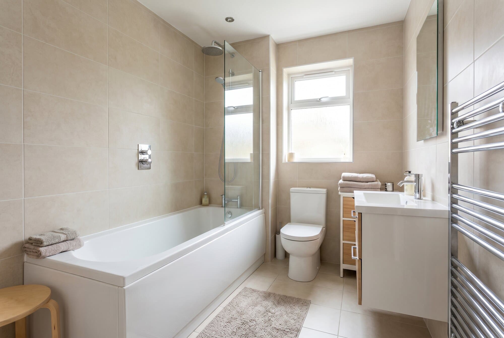 A well-planned family bathroom with a shower over the bath.