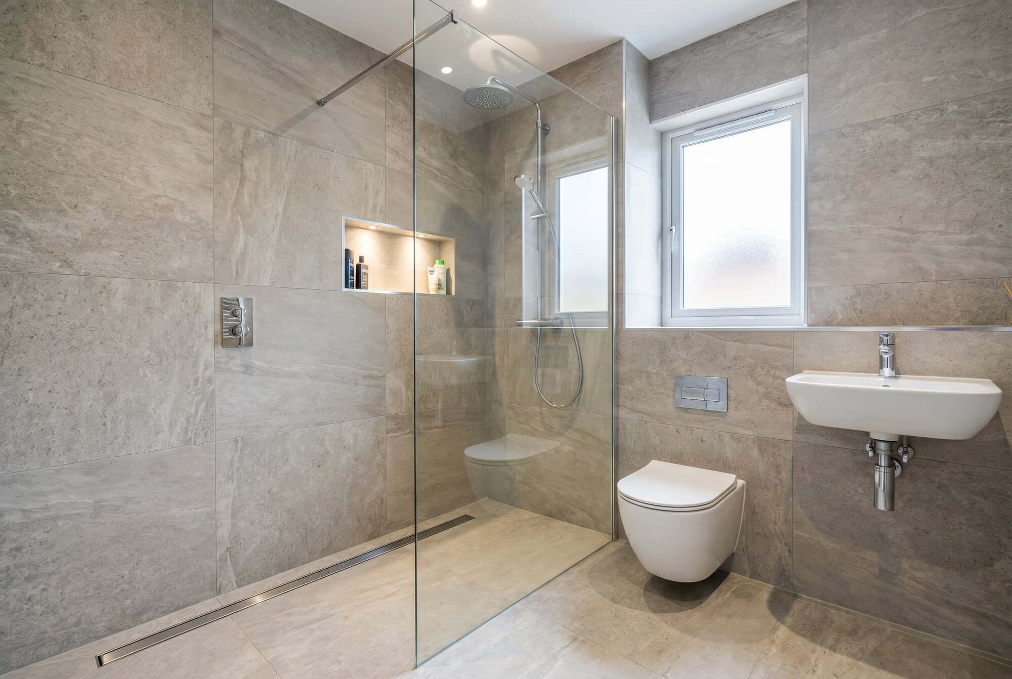 A level-access walk-in wet room, ideal for accessible bathroom design.
