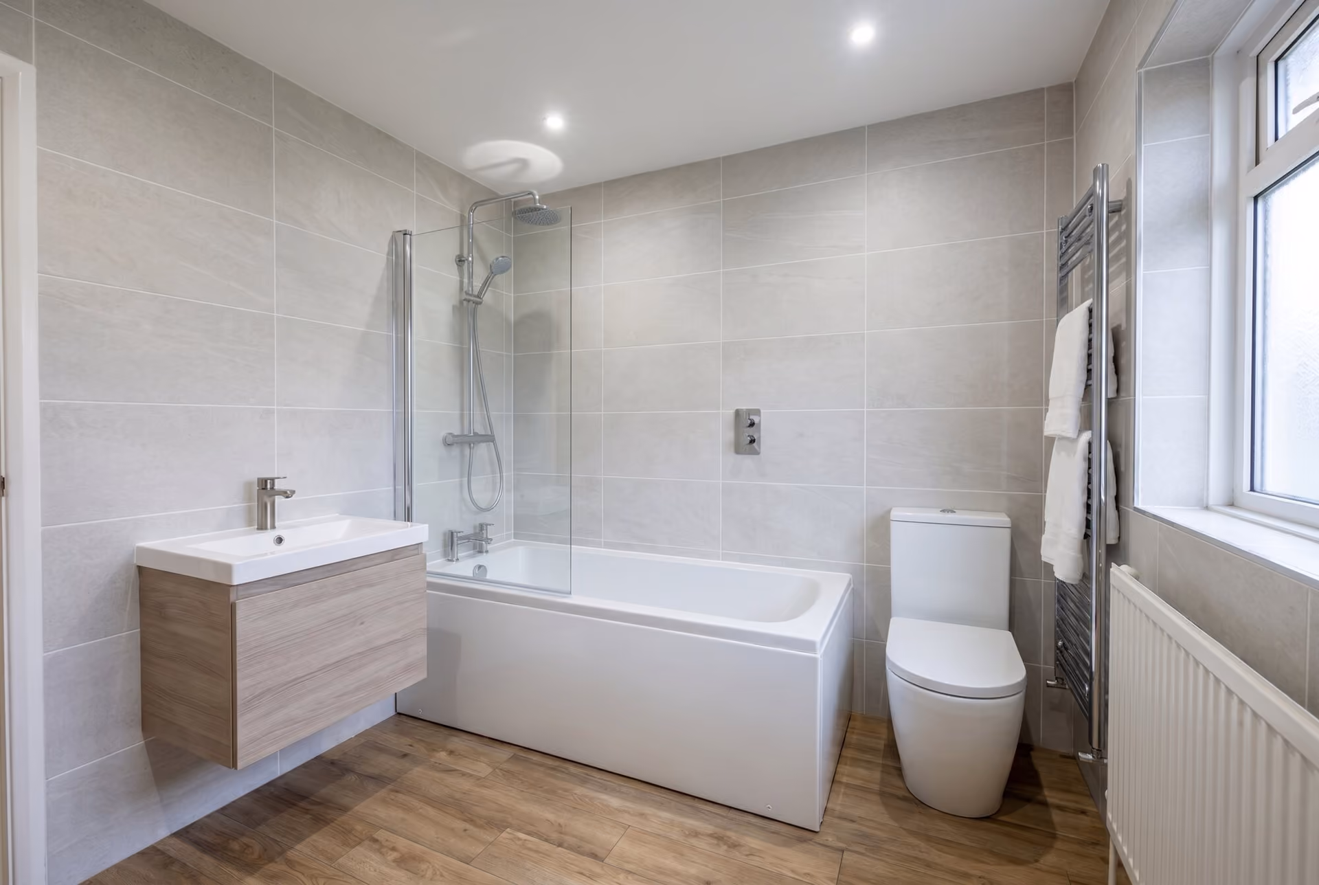 The same room transformed into a bright modern white bathroom.