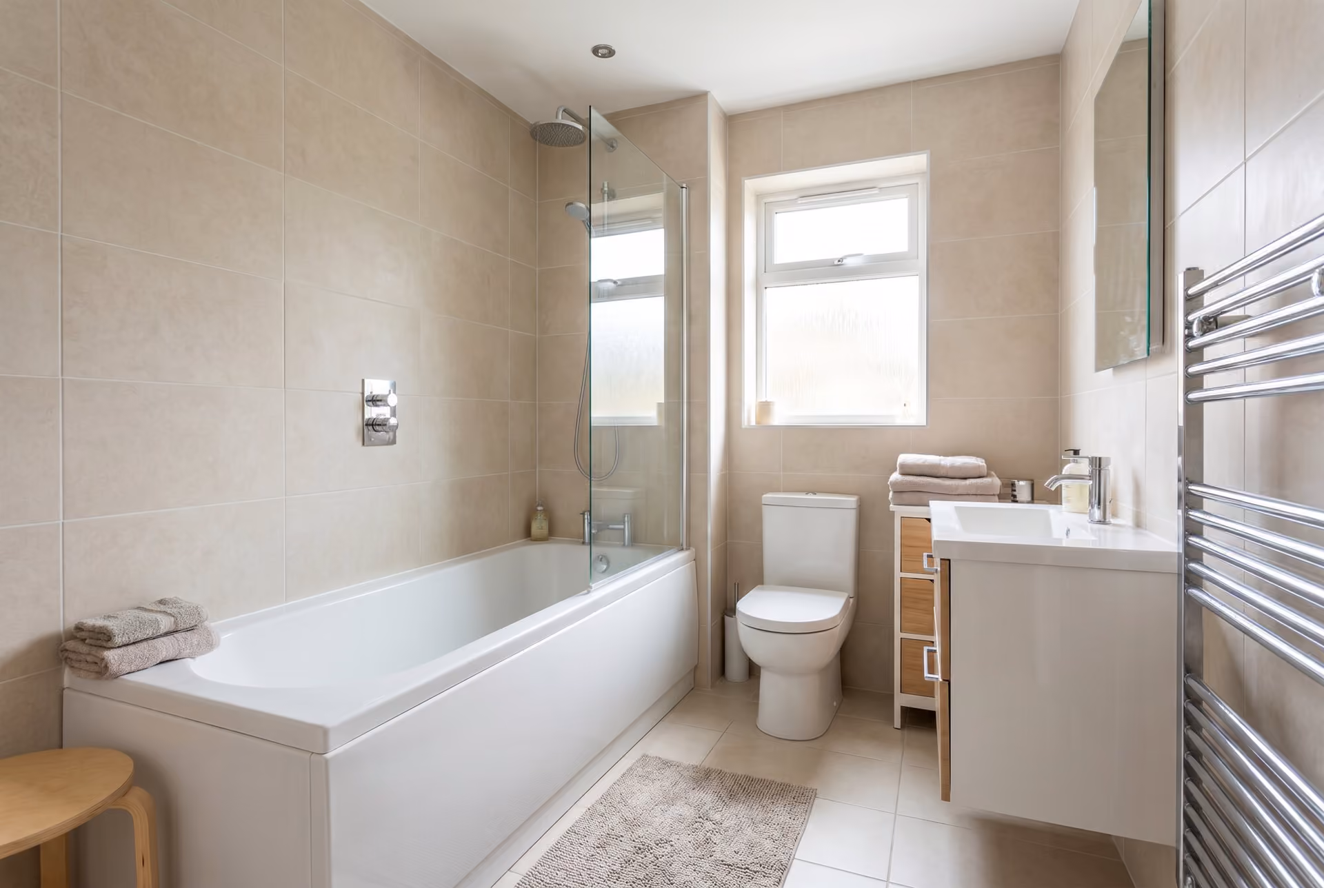 A well-planned family bathroom with a shower over the bath.